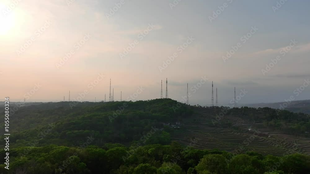 A telecommunications tower in sunset at the mountains A telecommunications tower in sunset at the mountains