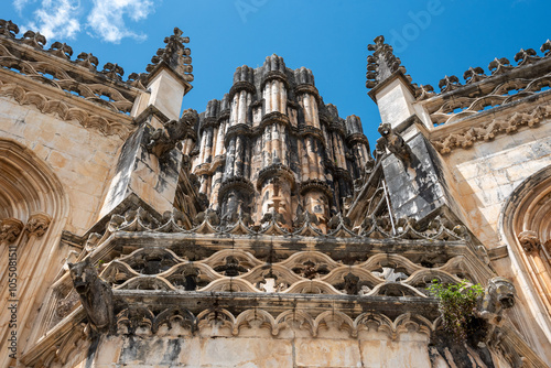 Picturesque detail of the facade of medieval Santa Maria da Vitoria monastery in Batalha, a manueline gothic masterpiece, view on the unfinished chapel photo