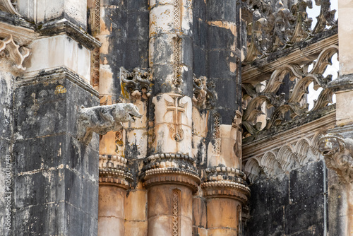Architectural detail and amusing gargoyles at the facade of medieval Santa Maria da Vitoria monastery church and the unfinished chapel in Batalha, a manueline gothic masterpiece