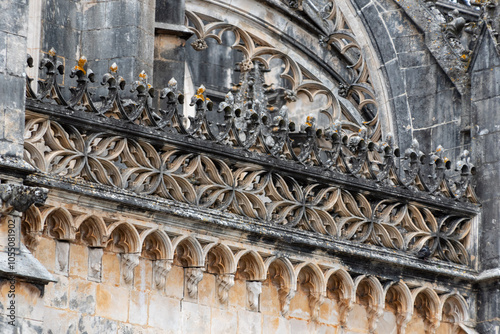 Picturesque facade of medieval Santa Maria da Vitoria monastery church in Batalha, a manueline gothic masterpiece, view on a facade detail at the founders chapel