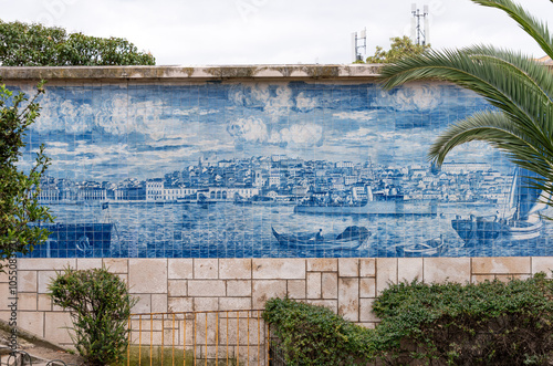 Intricate blue tile mural showcasing the coast of historic Lisbon, featuring old boats and skyline, the vibrant artwork captures cultural heritage and artistry, Alfama district of Lisbon