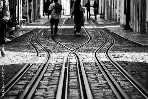 Tourists walking at the ascensor tracks at Bica de Duarte Belo street in old town Lisbon photo