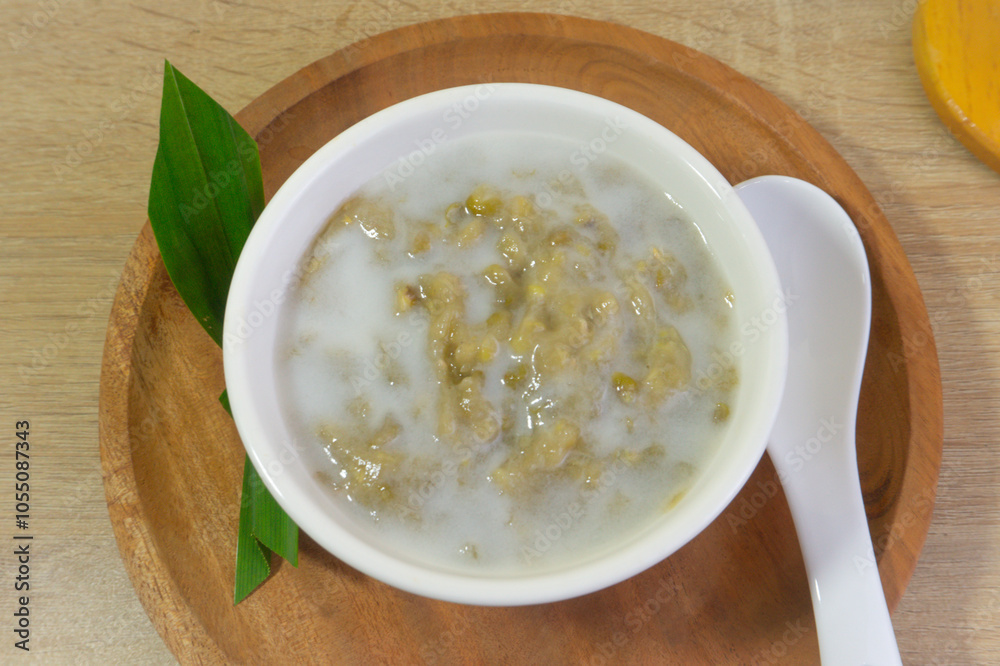 Mung Bean Porridge or Bubur Kacang Hijau, Indonesian dessert porridge of mung beans with coconut milk, pandan leaf and ginger. Mung Bean Porridge or Bubur Kacang Hijau, Indonesian dessert porridge of mung beans with coconut milk, pandan leaf and ginger.