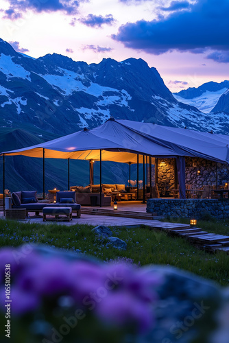 A luxurious outdoor lounge area with a mountain backdrop during sunset photo