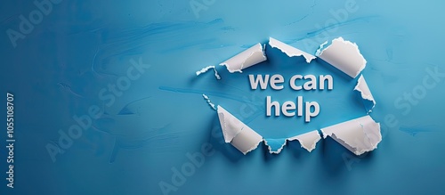 Ripped pieces of paper with we can help message on blue backdrop symbolizing assistance Includes a copy space image photo