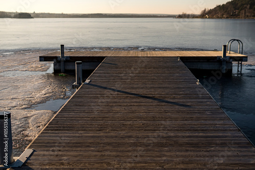 Small pier on a frozen lake in wintertime