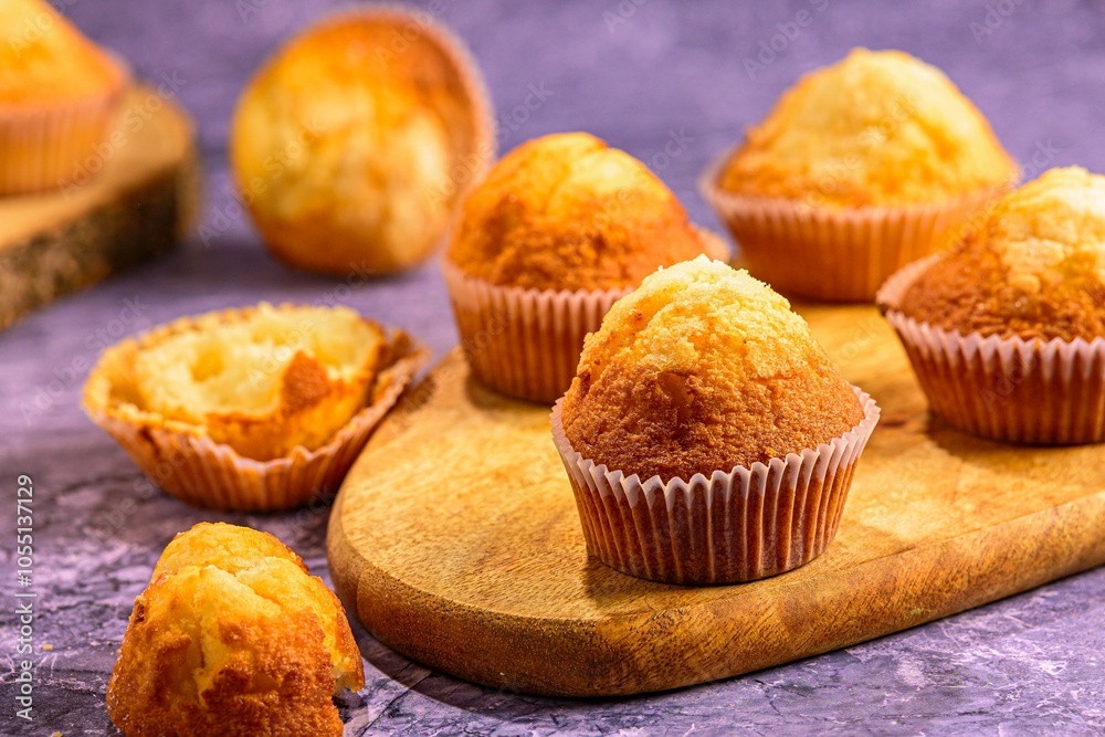 Freshly baked muffins on a wooden board. Freshly baked muffins on a wooden board.