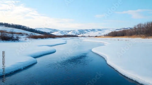 A Tranquil Winter Scene: Frozen River Reflecting the Serenity of a Clear Blue Sky and Snowy Hills. Winter Time Concept photo