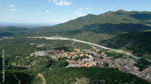 Aerial view of the village of perthus, france, nestled in the pyrenees mountains, as the sun moves across the sky, casting changing shadows photo