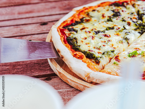 Pizza is cut into slices. Pizza is delicious, it is an Italian fast food and it is a universal food that everyone makes and knows all over the world.