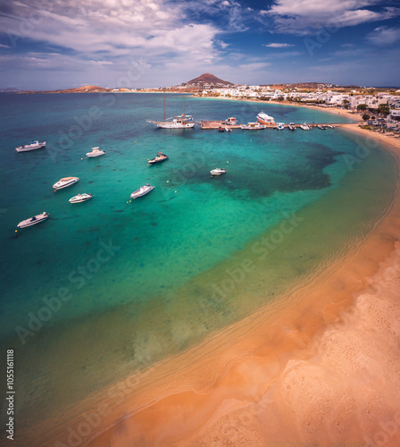 Obraz na płótnie A stunning view of Naxos Island, Greece, featuring crystal-clear turquoise waters, rugged coastlines, and charming white-washed buildings. A picturesque paradise for travelers and sun-seekers. w salonie