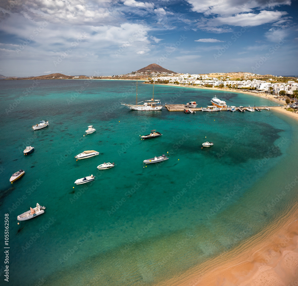 A stunning view of Naxos Island, Greece, featuring crystal-clear turquoise waters, rugged coastlines, and charming white-washed buildings. A picturesque paradise for travelers and sun-seekers.