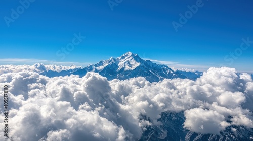 Majestic Mountain Peak Above Fluffy White Clouds