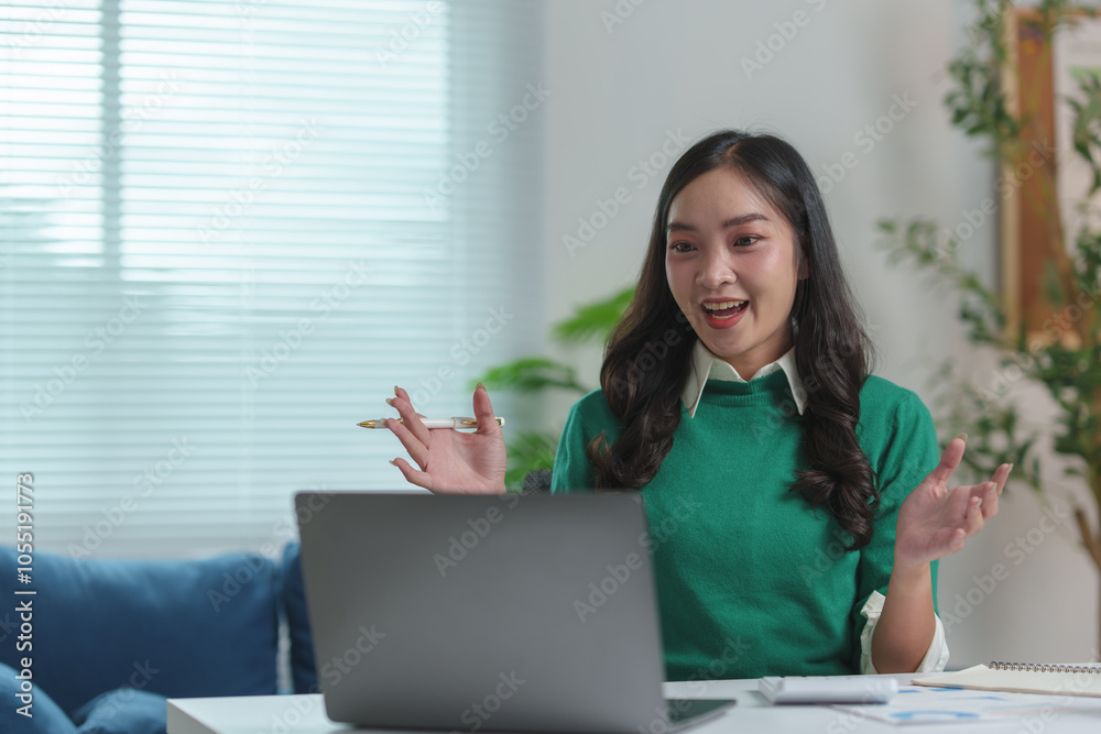 Businesswoman, cheerful young Asian woman sitting with laptop on sofa in home office Online learning, chatting, video calling, online business contacts working concept learning at home. Businesswoman, cheerful young Asian woman sitting with laptop on sofa in home office Online learning, chatting, video calling, online business contacts working concept learning at home.