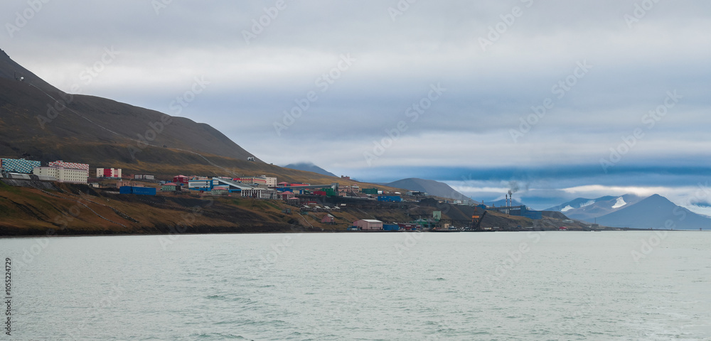 Colorful buildings along the coast of Barentsburg, Svalbard under a cloudy sky Colorful buildings along the coast of Barentsburg, Svalbard under a cloudy sky