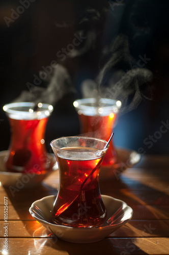 Obraz na plátně Beautiful backlit photo with shallow depth of field of Turkish tea served in tra