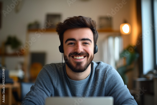 
A man wearing earphones relaxes in his home, immersed in music or a podcast while enjoying his personal space.