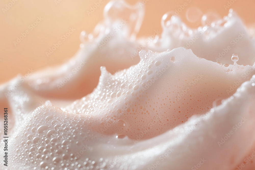close-up of an isolated cosmetic cream with bubbles and foam, spread on top of the creamy texture, against a soft peach background. close-up of an isolated cosmetic cream with bubbles and foam, spread on top of the creamy texture, against a soft peach background.