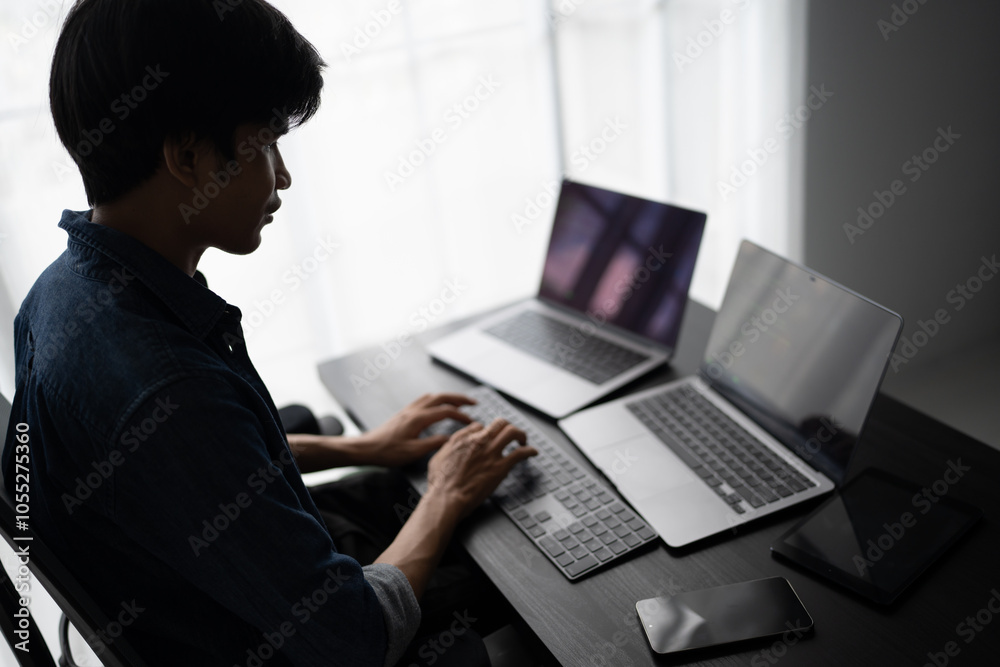 Asian man software engineer Working on Computer at office desk for writing program code IT Software Engineer finding errors tech support devops creating digital Asian man software engineer Working on Computer at office desk for writing program code IT Software Engineer finding errors tech support devops creating digital