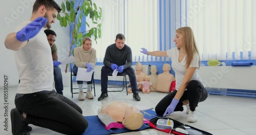 Stay away moment during the defibrillation process on a first aid group training indoors.