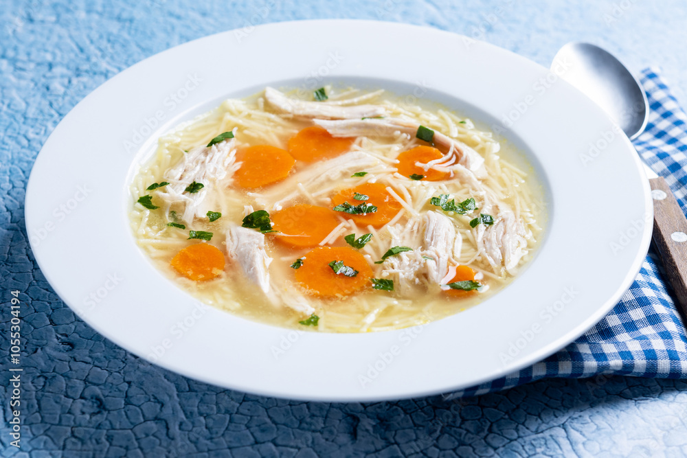 Homemade chicken soup on blue background Homemade chicken soup on blue background