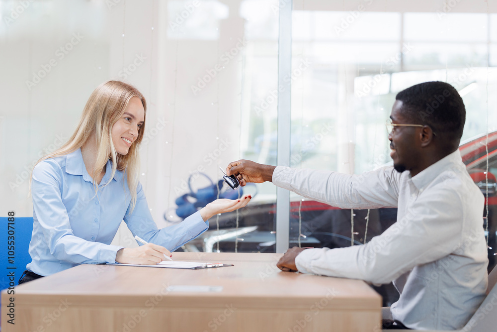 Happy owner young girl buys her first car, woman signs documents and receives keys at dealership Happy owner young girl buys her first car, woman signs documents and receives keys at dealership