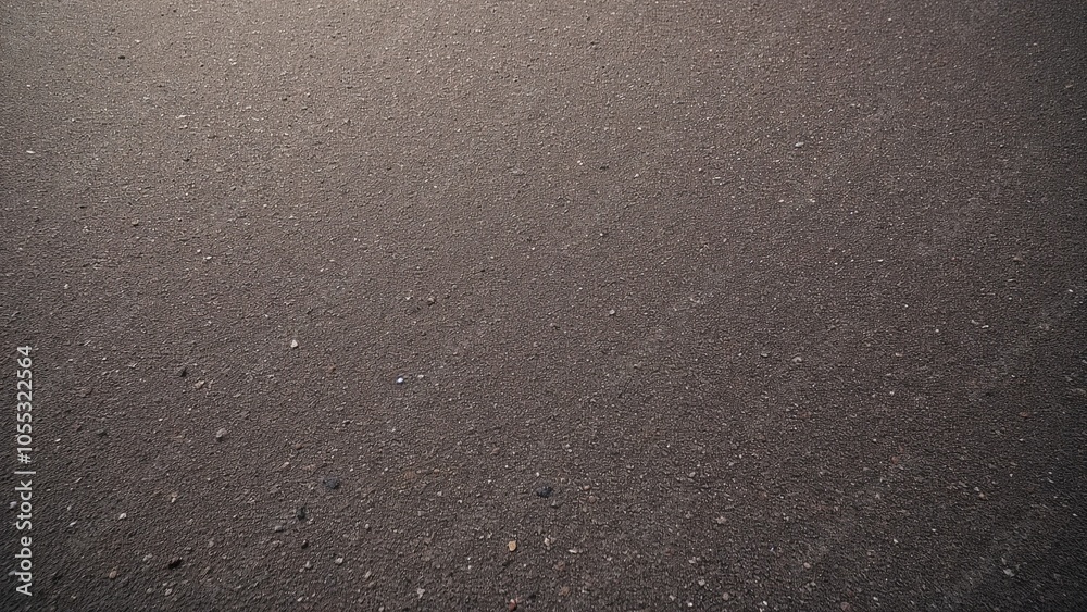 A textured view of an expansive gray sandy surface under soft natural light during early morning hours A textured view of an expansive gray sandy surface under soft natural light during early morning hours