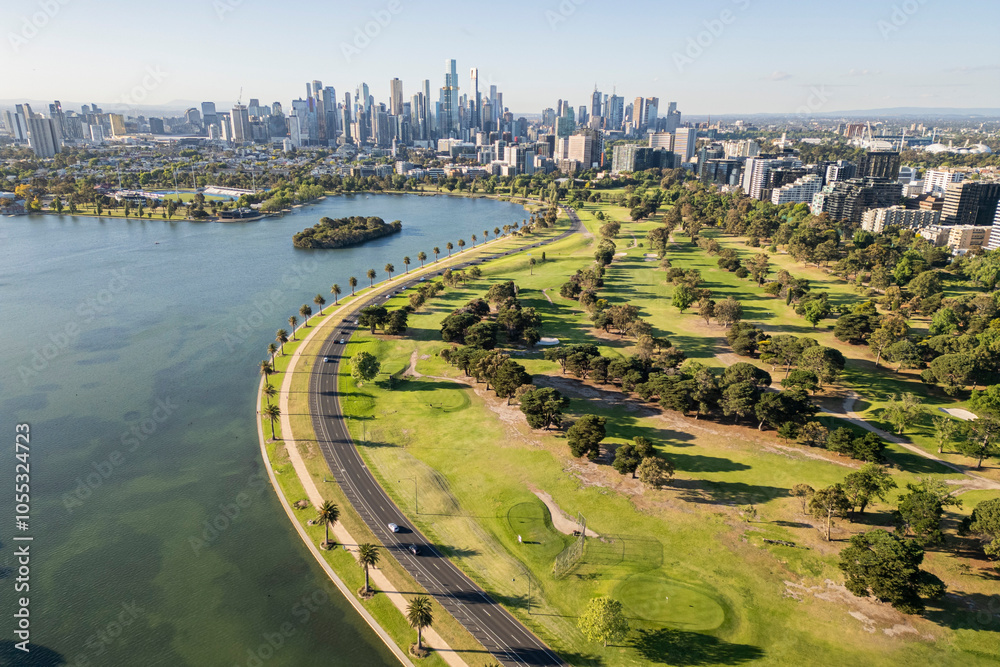 Fototapeta premium An Aerial view of Albert Park Lake and the Melbourne City Skyline on a sunny summer afternoon.
