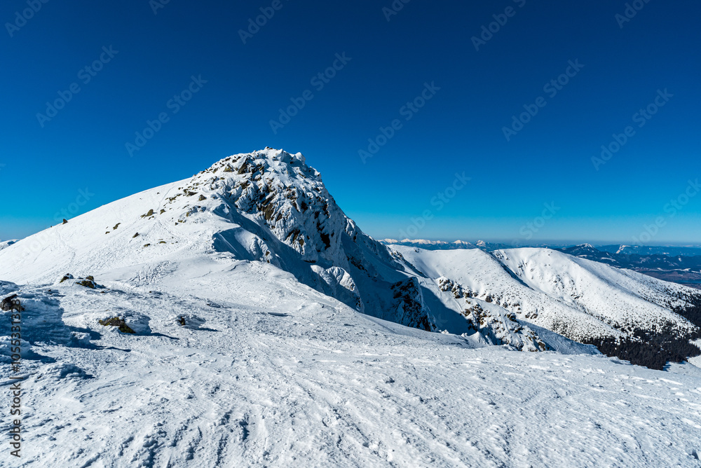 Derese hill in Nizke Tatry mountains with Mala Fatra, Velky Choc and Kubinska hola on the background in Slovakia during winter Derese hill in Nizke Tatry mountains with Mala Fatra, Velky Choc and Kubinska hola on the background in Slovakia during winter