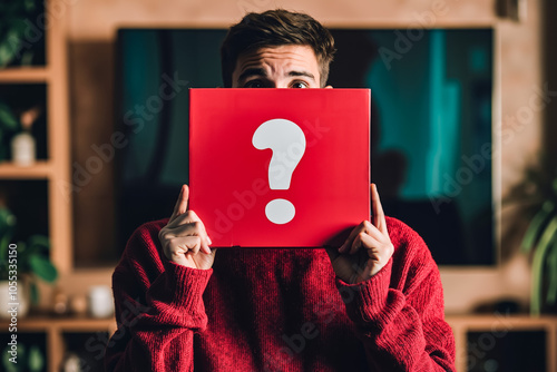 A man holding a red box with a question mark on it photo