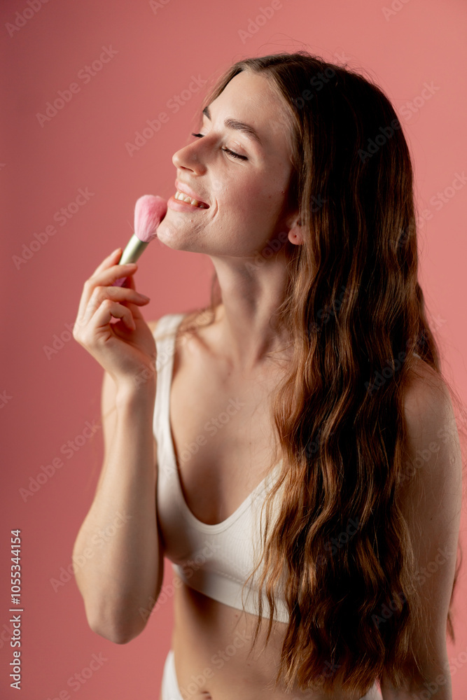 studio beauty shoot on pink background beautiful girl in white underwear standing with pink makeup brushes beauty salon smiling studio beauty shoot on pink background beautiful girl in white underwear standing with pink makeup brushes beauty salon smiling