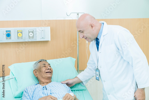 Doctor discuss to a patient in the hospital. Specialist male doctor describing the improving symptoms of elderly patient.