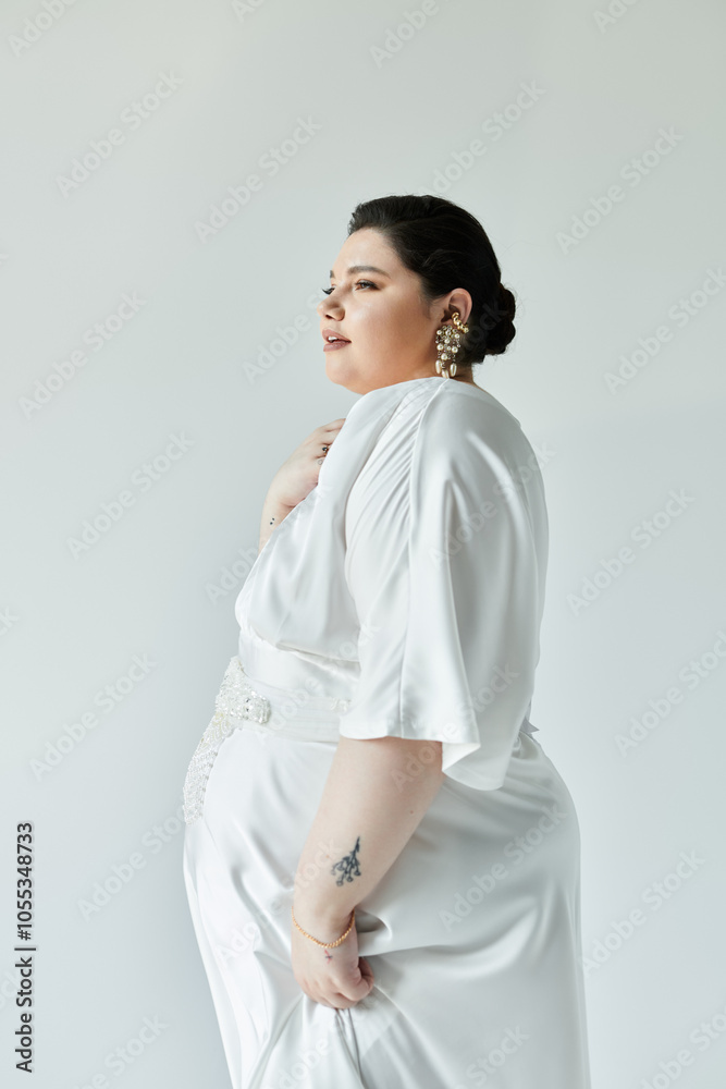 A radiant plus size bride gazes confidently, adorned in a flowing white gown with sparkling earrings. A radiant plus size bride gazes confidently, adorned in a flowing white gown with sparkling earrings.