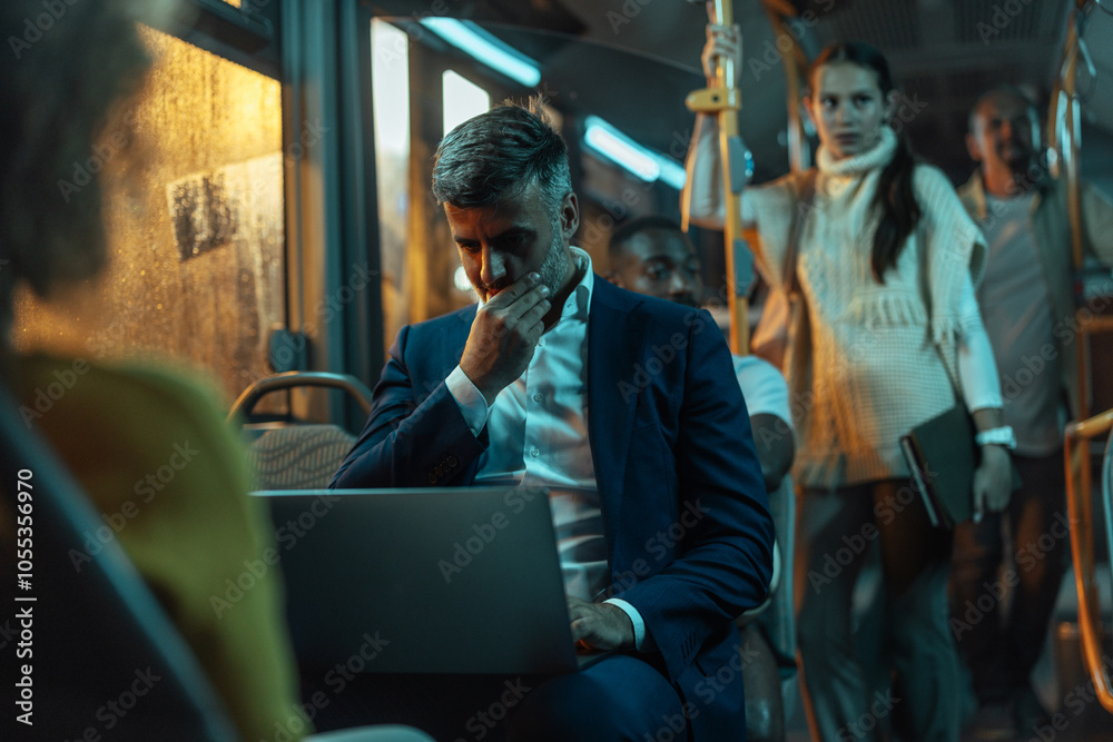 Businessman working on his laptop on a bus at night Businessman working on his laptop on a bus at night