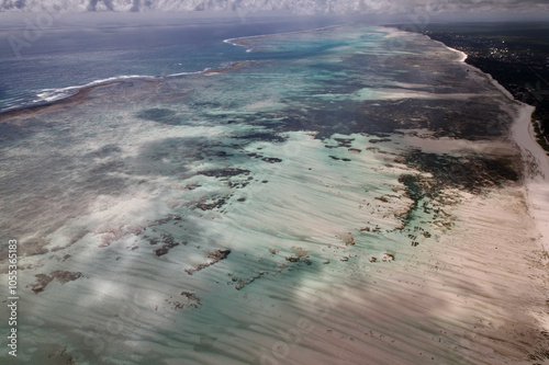 Aerial view of zanzibar east coast beach scene with beautiful turquoise water and sandy shoals, Paje, Tanzania. photo