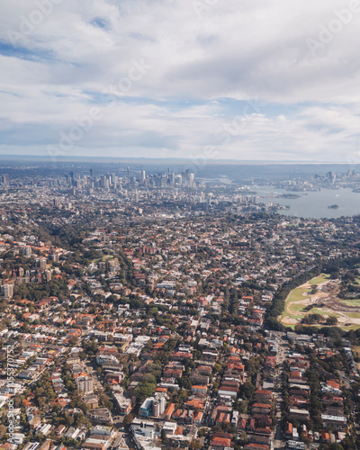 Aerial view of bondi beach and sydney cityscape under a cloudy sky, new south wales, australia. photo