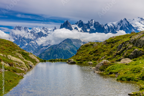 Lake in the Alps. Mountain lake high altitude lagoon surrounded with mountain peaks picturesque landscape of alpine scene in summer. Turquoise water of lagunas in french and italian Alps