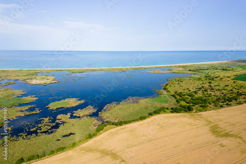 Durankulak, Bulgaria - 12 June 2024: Aerial view of tranquil Durankulak Lake meeting the beautiful Black Sea coastline, Durankulak, Bulgaria.