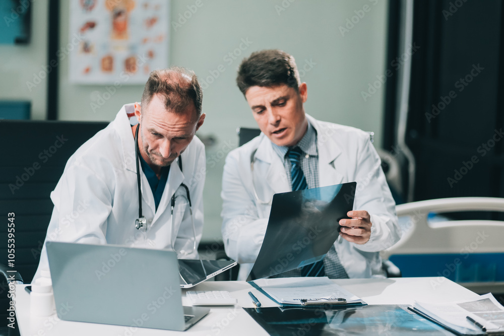 Group of medical practitioners working together and analyzing medical scan in the hospital Group of medical practitioners working together and analyzing medical scan in the hospital