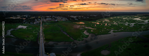 Aerial view of serene sunset over marsh and estuary with winding river and mountains, Wells, Maine, United States. photo