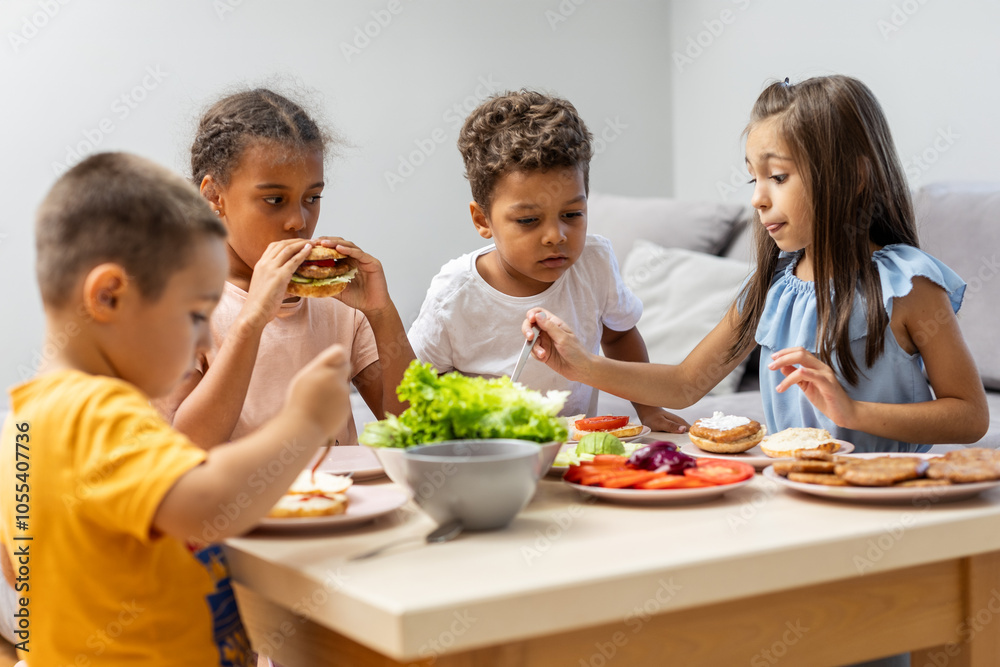 Children enjoying a healthy meal together indoors. Children enjoying a healthy meal together indoors.