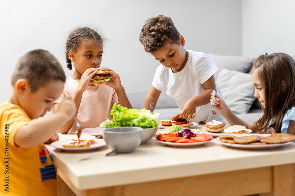 Children enjoying lunch around a table with salads. Children enjoying lunch around a table with salads.