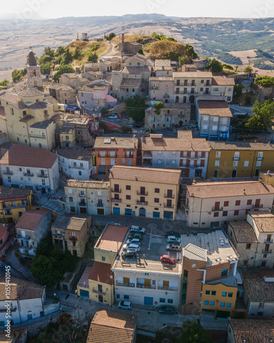 Aerial view of Cairano township on hilltop with Conza lake in background at sunset, Cairano, Irpinia, Italy. photo