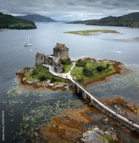 Aerial view of the beautiful Eilean Donan Castle on a serene island surrounded by tranquil waters and a scenic landscape, Dornie, United Kingdom. photo