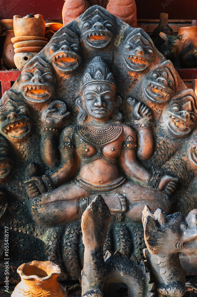 Clay Buddhist figurine statue of the god Shiva in a souvenir shop in Vietnam in Asia Clay Buddhist figurine statue of the god Shiva in a souvenir shop in Vietnam in Asia