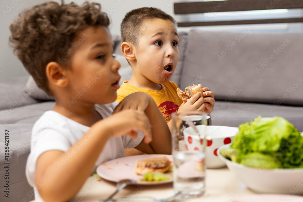 Two Kids Enjoying a Meal Together at the Table Two Kids Enjoying a Meal Together at the Table