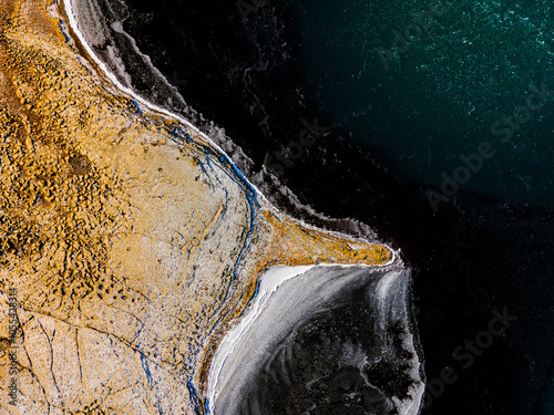 Aerial view of Vordufell mountain and rugged coastline with tranquil water, Laugaras, Iceland. photo