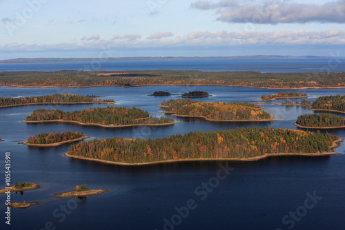 Aerial view of tranquil islands and serene lake surrounded by picturesque forest in Vodlozero National Park, Republic of Karelia, Russia. photo