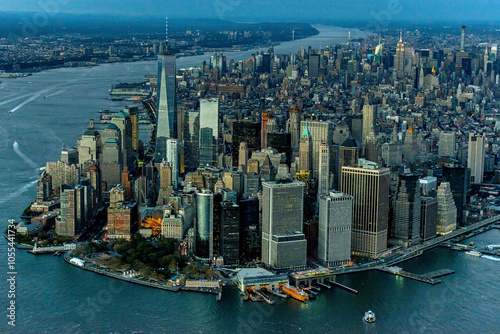 Aerial view of vibrant financial district with iconic skyscrapers and the East River at nightfall, New York, United States. photo