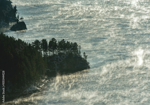 Aerial view of the serene and winding Yenisei River surrounded by tranquil forests and mist, Khakassia Republic, Russia. photo